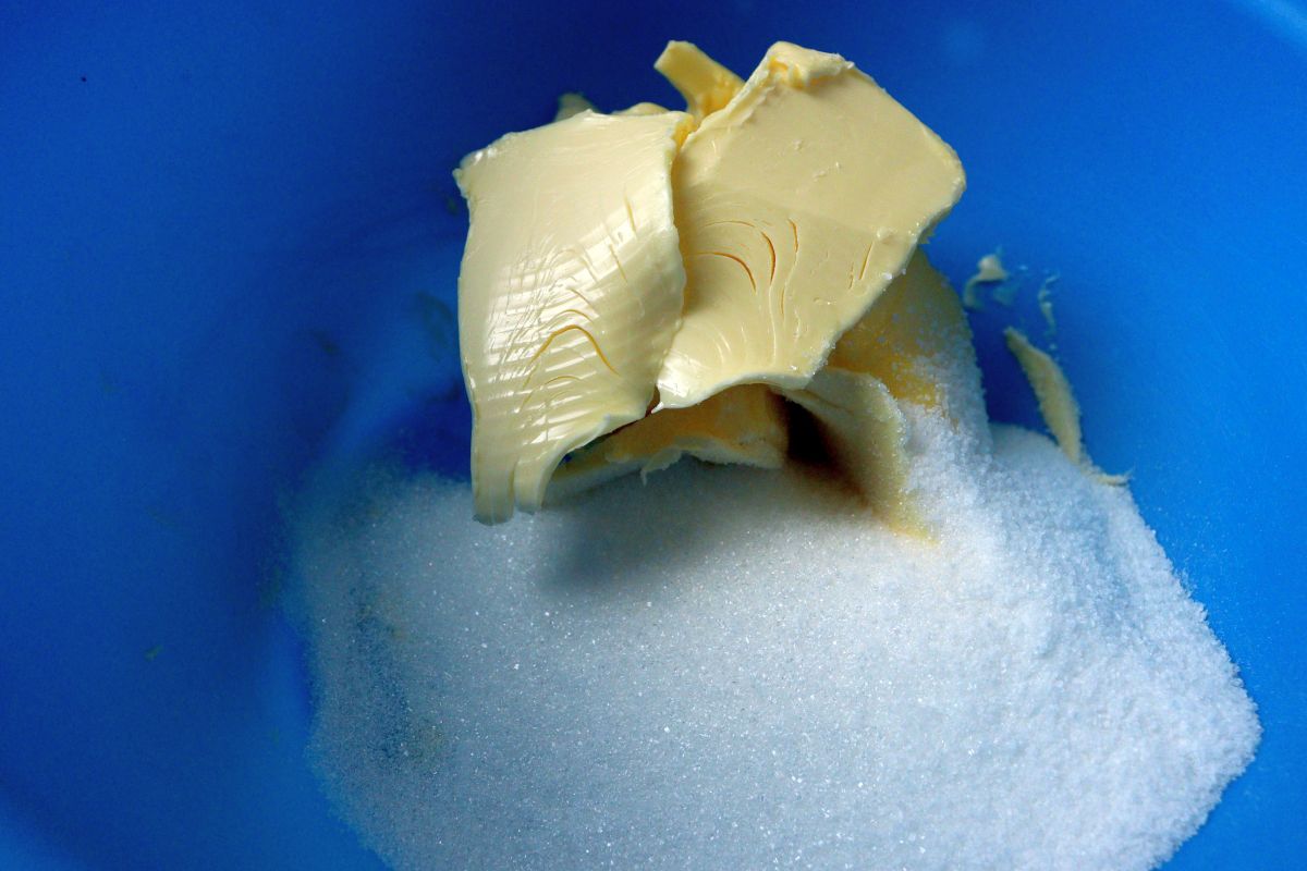 Soft butter and sugar in a blue bowl