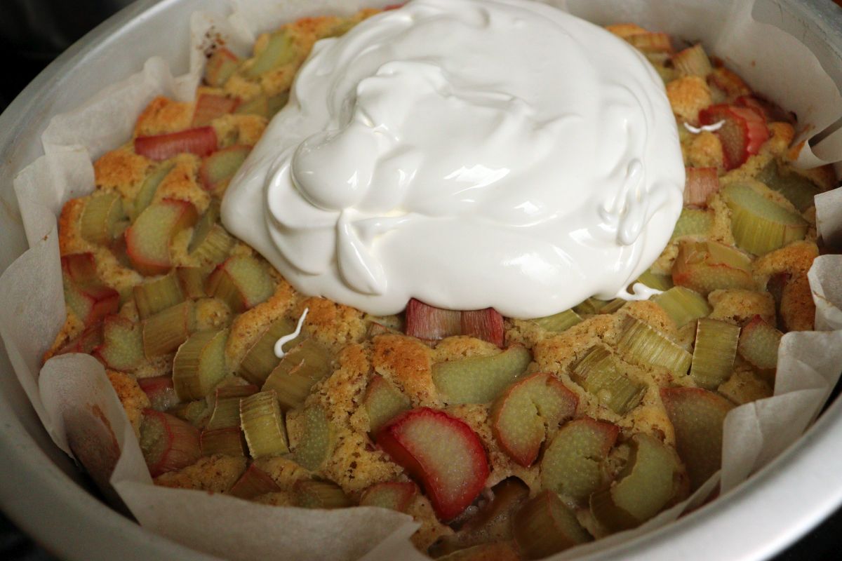 Egg whites added on top of a baked rhubarb cake 