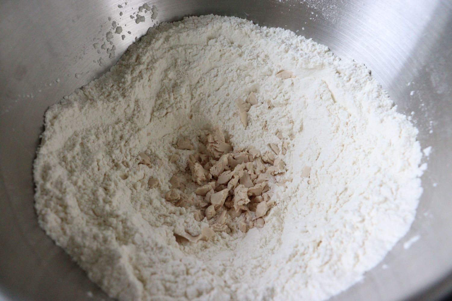 Flour mixed with salt and added yeast in the middle for Yeast Dough - Hefeteig. 