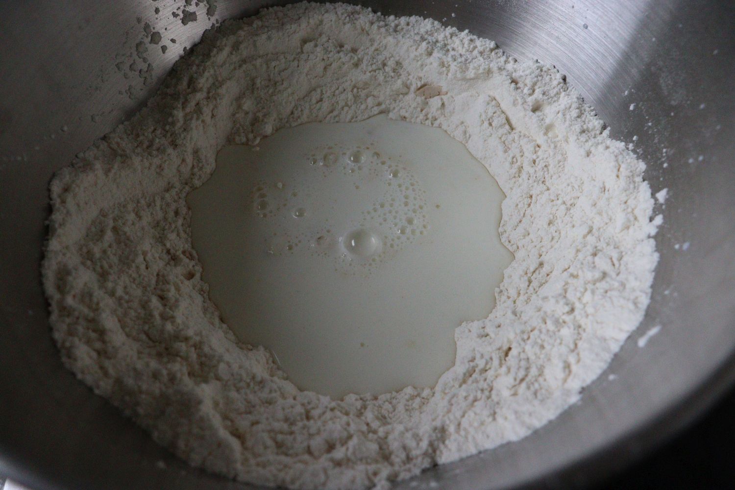 Flour mixed with salt, added yeast, sugar and milk in the middle, for Yeast Dough - Hefeteig. 