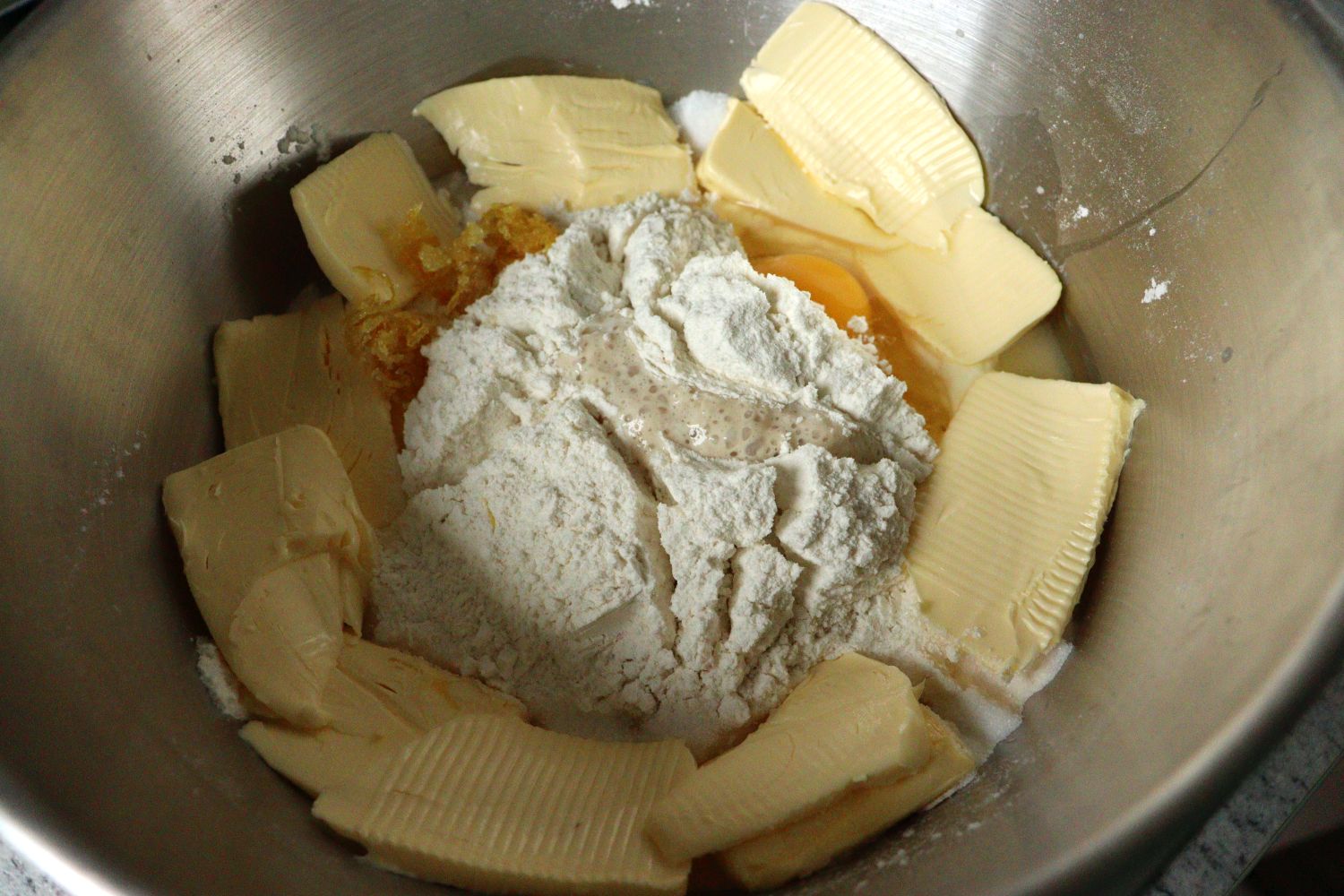 Proofed yeast dough to which butter, egg, sugar, lemon peel and vanilla sugar is added to make a Yeast Dough - Hefeteig used for baking for sweets.