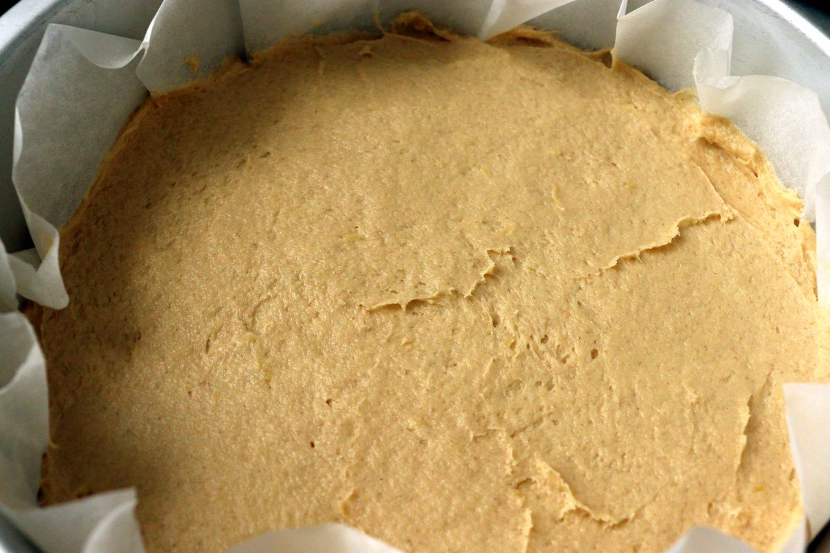 Thick batter leveled in a pan for a rhubarb cake