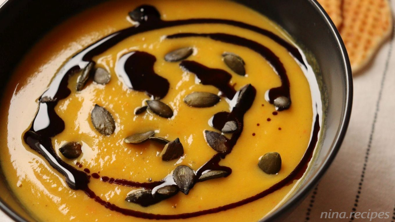 Pumpkin soup with vegetables, no broth, garnished with pumpkin seeds oil and roasted pumpkin seeds