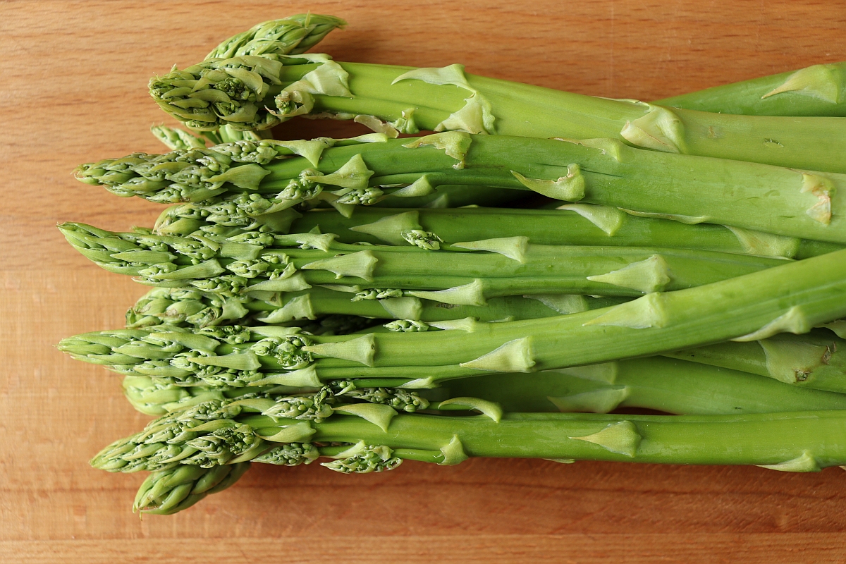 Green Asparagus on a wooden chopping board