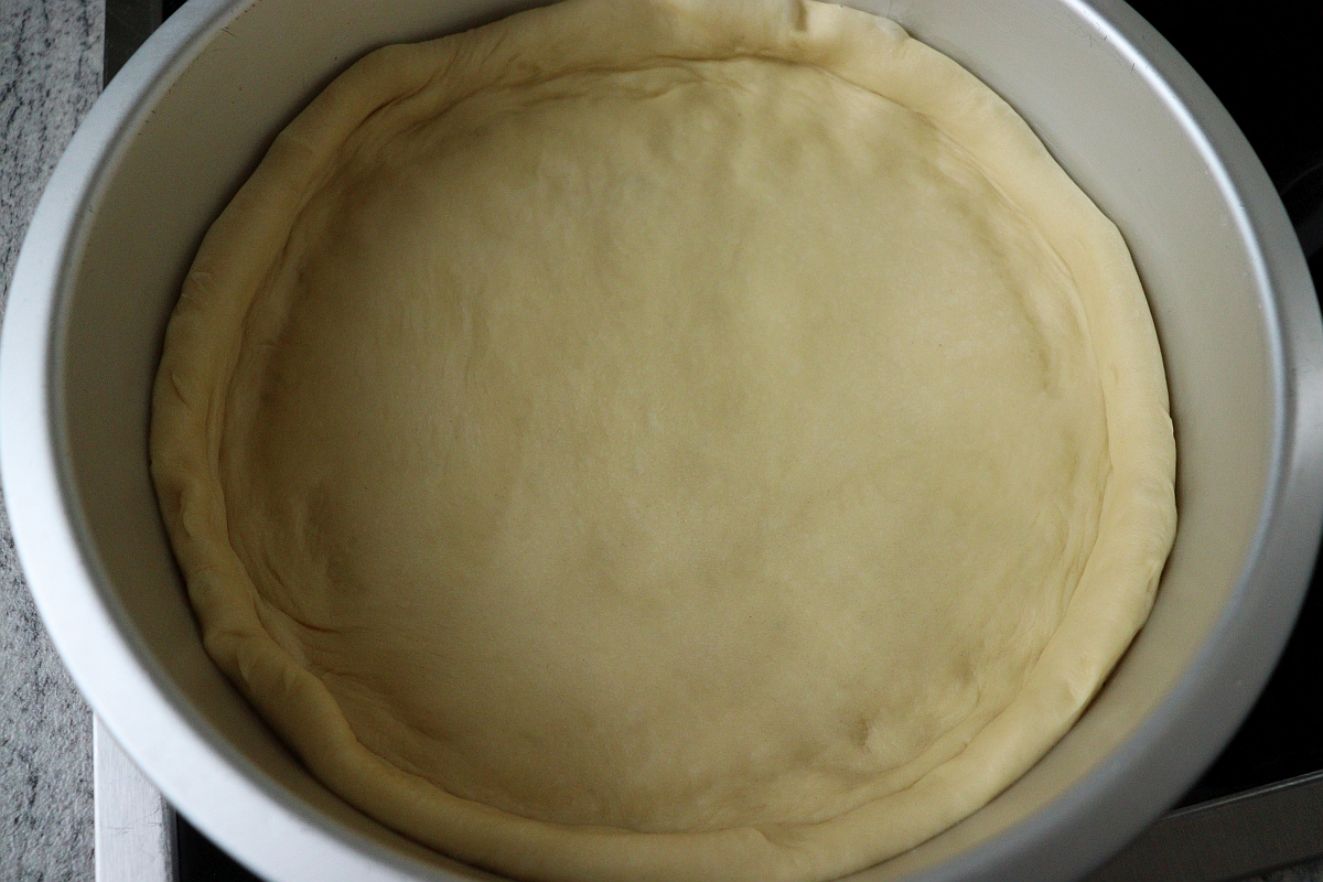 yeast dough in a springform pan for rhubarb crumble cake