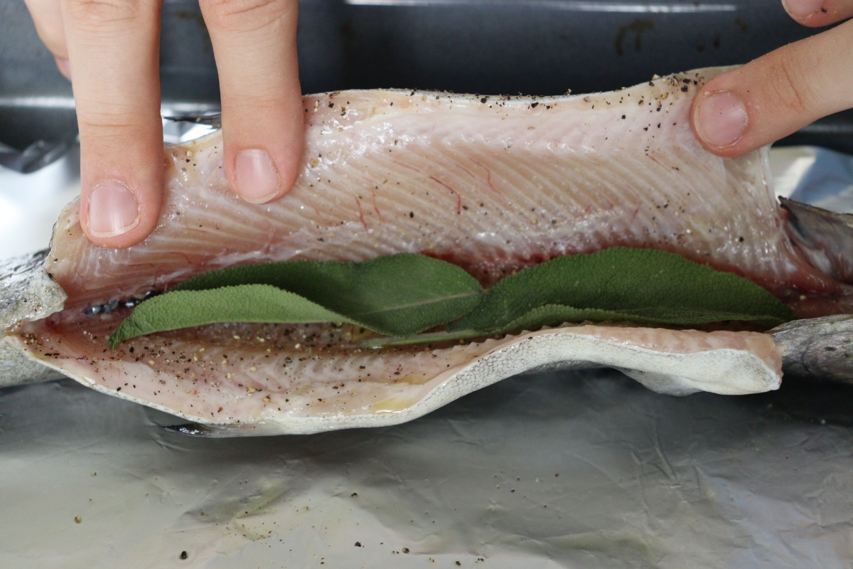 Trout coated with olive oil, salt pepper and stuffed with sage leaves