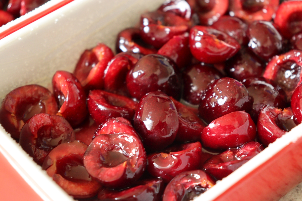 Black cherries in a buttered and sugared pan, for cherry clafoutis