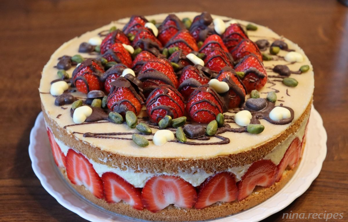 Fraisier cake (Fraisier Torte), french strawberry layered cake with a butter custard vanilla cream, many strawberries, a marzipan top and chocolate decor