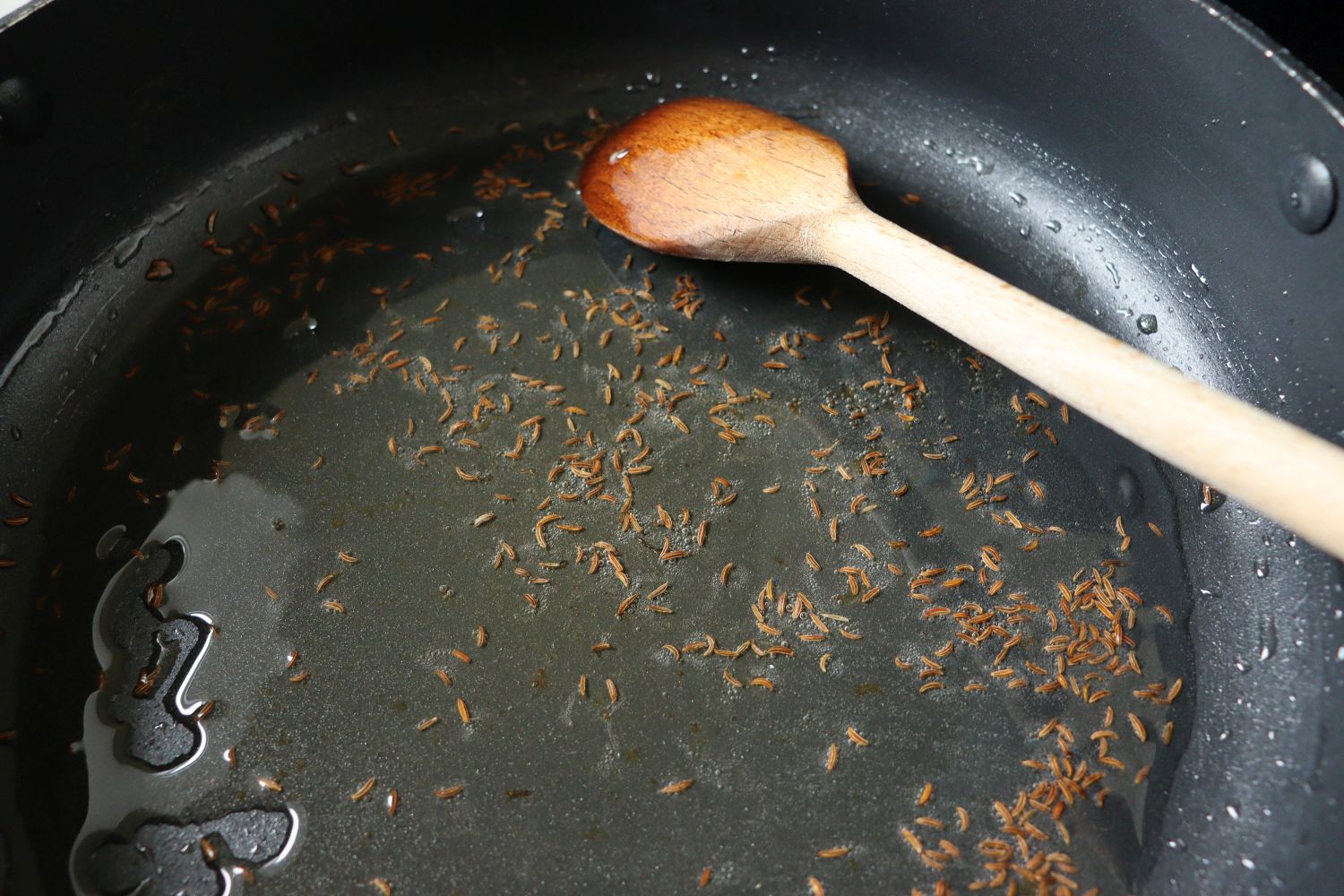 Roasting caraway seeds in a pan for Hungarian Goulash