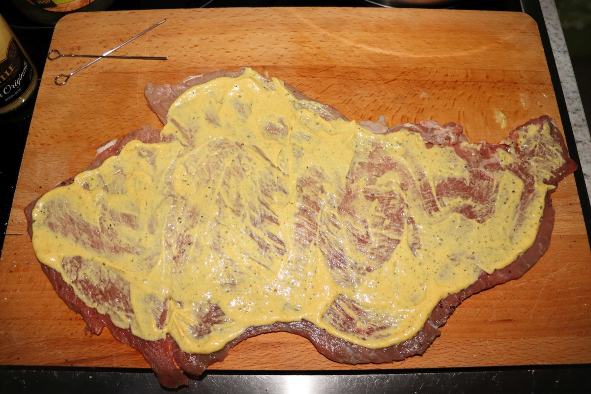Beef slice covered in mustard for Rinderrouladen
